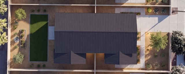 Aerial rendering of a single duplex on its lot — one building, two mirrored units, with parking and yard.